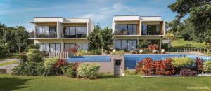 a house with a swimming pool in front of it at Gunita Villas in Santo Tomas