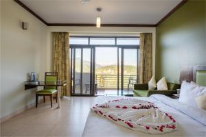 Voodi või voodid majutusasutuse Revathi Resorts toas