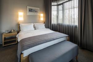 a bedroom with a large bed and a window at Taxim Suites Residences Istanbul in Istanbul