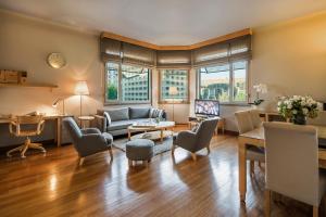 a living room with a couch and a table at Taxim Suites Residences Istanbul in Istanbul