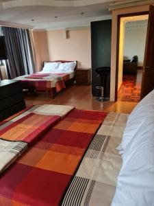 a hotel room with two beds and a colorful rug at Omni Tower 2 Bed Room Sukhumbit Best Apartment in Bang Kapi