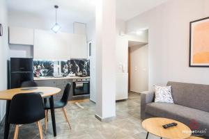 una sala de estar con un sofá y una mesa en Filoxenia apart by homebrain, en Alexandroupoli