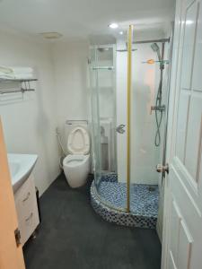 a bathroom with a shower with a toilet and a sink at Omni Tower 2 Bed Room Sukhumbit Best Apartment in Bang Kapi