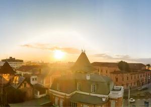 a view of a city with the sun setting at Valiha Hotel Antananarivo in Antananarivo