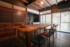 comedor con mesa de madera y sillas en 赭Soho Yunotsu Old Village Inn & Bar, en Ōmorichō