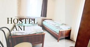 two twin beds in a room with a hostel am at Ani Hostel Gyumri in Gyumri