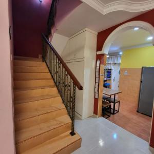 a staircase in a house with a dining room at Homestay LA Kota Bharu in Kota Bharu