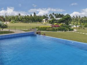 una gran piscina azul frente a un patio en Gunita Villas, en Santo Tomás