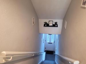 a hallway with a blue and white hallway at Luke Stays - Rokeby Street in Lemington