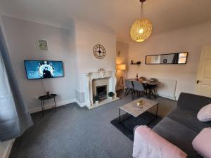 a living room with a couch and a fireplace at Luke Stays - Rokeby Street in Lemington