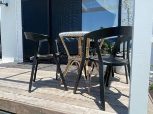 two chairs and a table on a patio at Quarterdeck Lakes Entrance 2br *Waterfront* Apartment in Lakes Entrance
