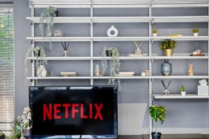 a netflix sign sitting on a shelf at Livestay-Camden Mews House with Private Roof Terrace in London