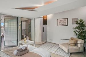 a living room with a ceiling fan and a couch at Livestay-Camden Mews House with Private Roof Terrace in London