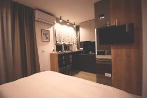 a hotel room with a bed and a television in it at TOP Room in Šabac