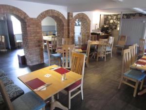 a restaurant with tables and chairs in a room at The Wheatsheaf in Crick