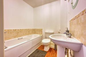 a bathroom with a tub and a toilet and a sink at Blue Cedar 2 Bed, 2 Bath Apt with Parking, Birmingham by 360Midlands in Sutton Coldfield