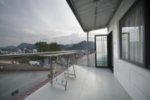 a balcony of a building with a view of a city at Qianxun Tea House & Homestay in Wuyishan