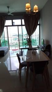 a living room with a table and a large window at 11-Modern HOMESTAY PALAZIO lake view Mount Austin Palazio near AEON Themepark Toppen IKEA in Johor Bahru +9 photos