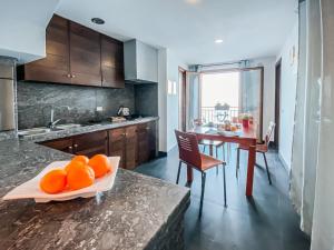a kitchen with a table with oranges on a counter at Terrazza Roberto in Cefalù