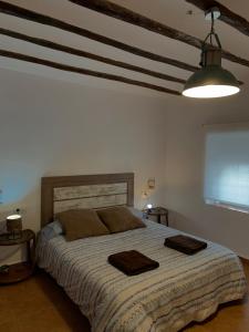 a bedroom with a large bed with two towels on it at Casa Rural "La villa del pistacho" in Archivel +69 photos