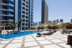 a pool in the middle of a city with tall buildings at Maison Privee - Stunning Apartment with Dubai Marina View in Dubai