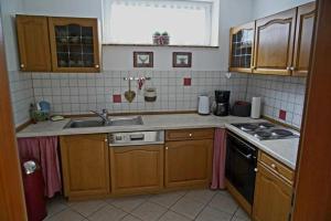 a kitchen with a sink and a stove at Ferienwohnung Espenau in Espenau
