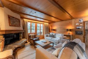 - un salon avec un canapé et une cheminée dans l'établissement Charming Alpine Apartment Gstaad, à Gstaad