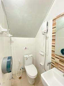 a small bathroom with a toilet and a sink at Sleepbox Hostel Suratthani in Surat Thani