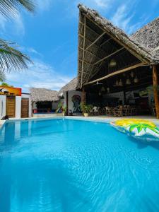 a large swimming pool in front of a resort at Babalao Bungalows in Nungwi