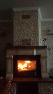 a fireplace in a living room with a fire in it at Peaceful house Velika Kladusa 1km from centre in Velika Kladuša