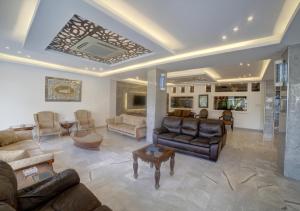 a large living room with couches and a table at Shweiki International Hotel in Aqaba