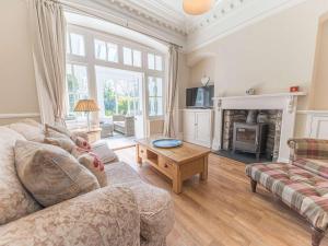 a living room with a couch and a fireplace at Southfield is a spacious period five bed, four bath with parking in Kendal