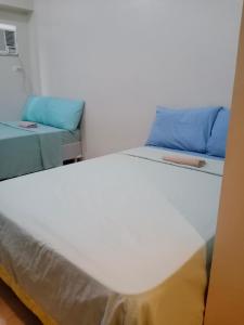 a room with a bed and a couch at Sunvida Cebu in Cebu City