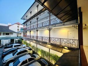 a group of cars parked in a parking lot at INN Kham Apartment in Chiang Mai