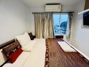 Postel nebo postele na pokoji v ubytování INN Kham Apartment + 27 fotografií