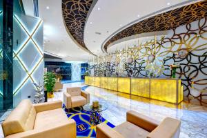 a lobby of a hotel with couches and chairs at Gevora Hotel in Dubai