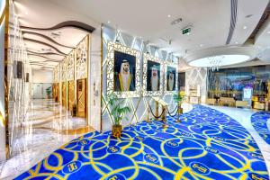 a lobby with a blue and yellow carpet at Gevora Hotel in Dubai