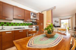 a kitchen with a table with a potted plant on it at Casa il grande Carrubo in Santa Maria Navarrese