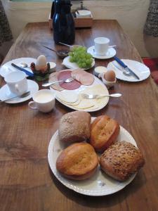 drewniany stół z talerzami chleba i jaj w obiekcie Der Schnuckenhof w mieście Schneverdingen