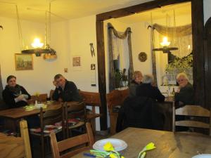 un grupo de personas sentadas en mesas en un restaurante en Der Schnuckenhof en Schneverdingen