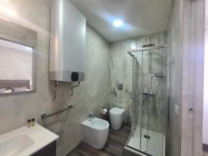 a bathroom with a shower and a toilet and a sink at Apartment Udine in Udine