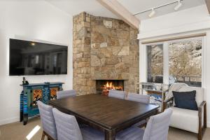 a dining room with a table and a fireplace at Standard Three Bedroom - Aspen Alps #406 in Aspen