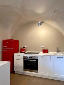 インペリアにあるAgriturismo Uliveto Sagliettoのキッチン(コンロ、赤い冷蔵庫付)