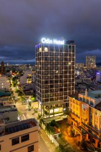 a building with a hotel sign on top of it at Odin Hotel Quy Nhon in Quy Nhon