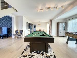 a living room with a pool table in it at VILLA BELLA VISTA - Proche Rennes - Billard - Baby-foot in Liffré