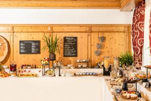a bakery with a counter with bread and pastries at Hotel Residence Panorama La Forca, GTSGroup in Tignale