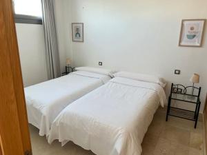 En eller flere senge i et værelse på Corralejo Apartment