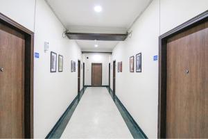 a corridor of a hospital hallway with doors at FabHotel Radiant Inn DLF Phase 3 in Gurgaon