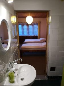 a bathroom with a sink and a mirror and a bed at Golden View Villa - Great place for vacations in Przesieka