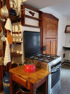 a kitchen with a stove and a tea kettle on a table at Golden View Villa - Great place for vacations in Przesieka